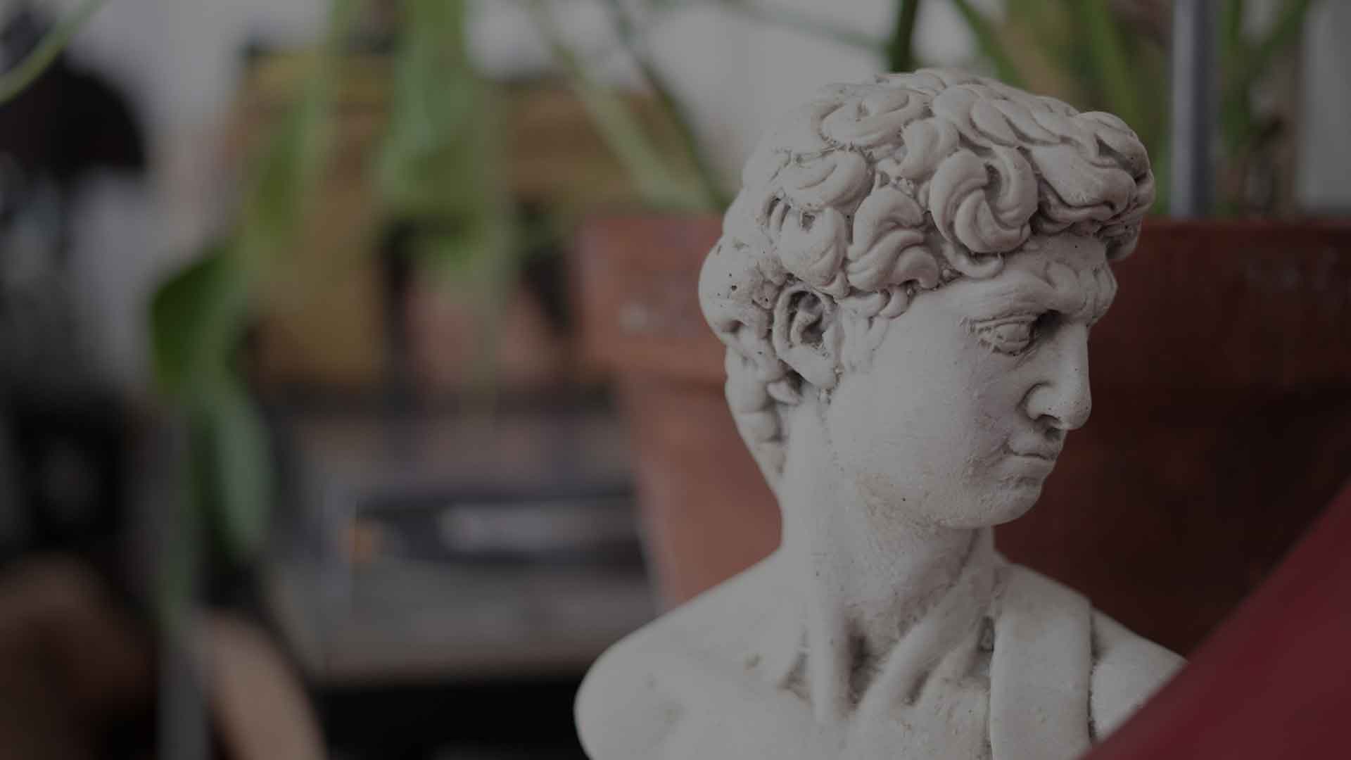 A plaster bust of David among the plants